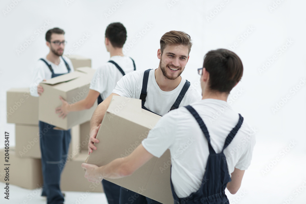 Portrait of movers holding box smiling isolated on white backgro