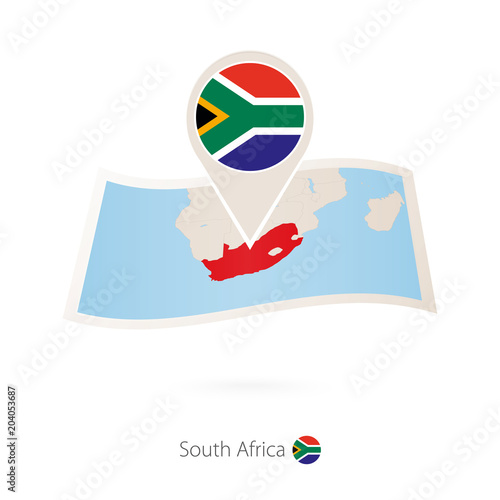 Folded paper map of South Africa with flag pin of South Africa.