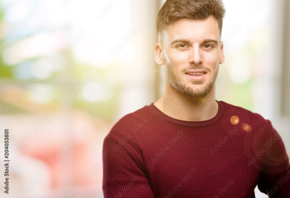Handsome young man holding something in his empty hand Handsome young man holding something in his empty hand