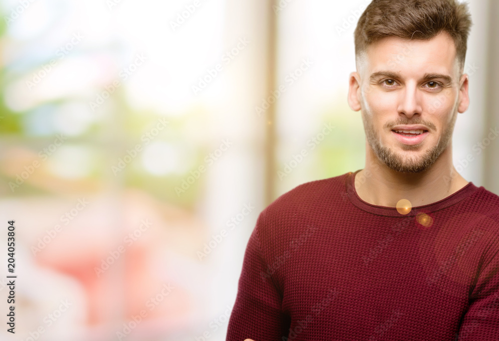 Handsome young man holding something in his empty hand Handsome young man holding something in his empty hand