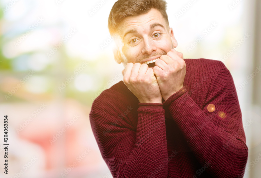 Handsome young man happy and surprised cheering expressing wow gesture Handsome young man happy and surprised cheering expressing wow gesture