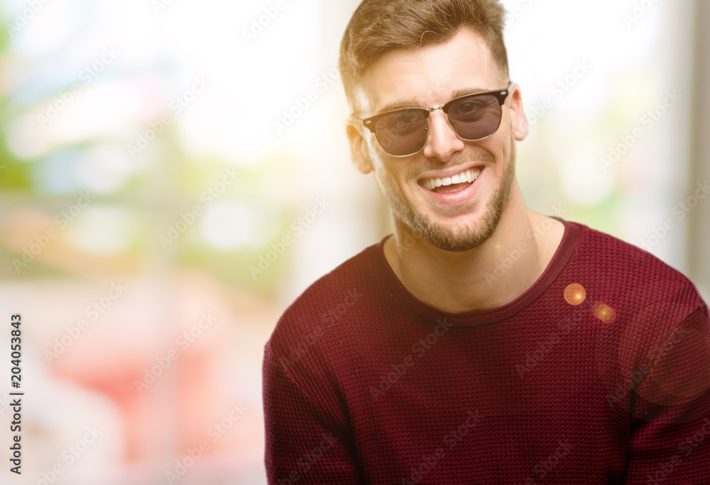 Handsome young man happy and surprised cheering expressing wow gesture Handsome young man happy and surprised cheering expressing wow gesture
