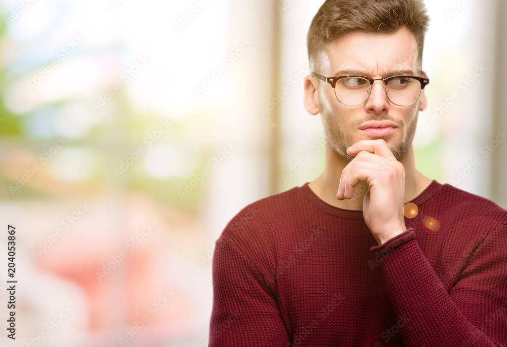 Handsome young man doubt expression, confuse and wonder concept, uncertain future Handsome young man doubt expression, confuse and wonder concept, uncertain future