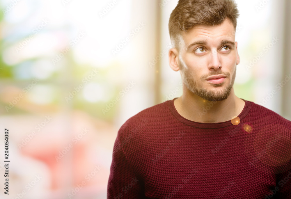 Handsome young man doubt expression, confuse and wonder concept, uncertain future Handsome young man doubt expression, confuse and wonder concept, uncertain future