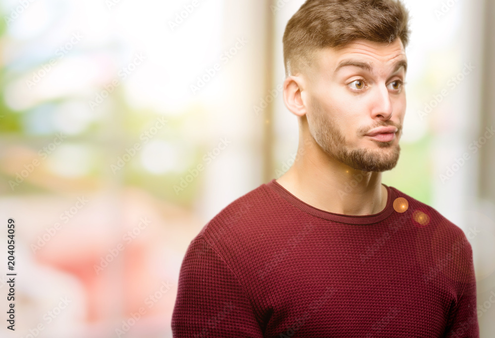 Handsome young man making funny face fooling Handsome young man making funny face fooling