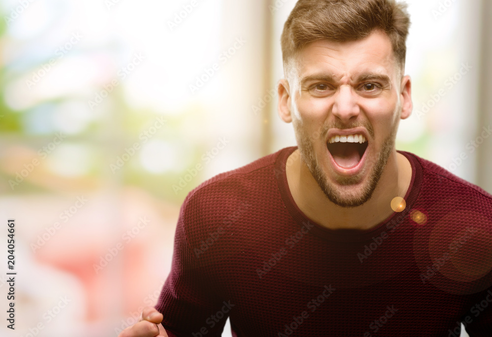 Handsome young man happy and excited celebrating victory expressing big success, power, energy and positive emotions. Celebrates new job joyful Handsome young man happy and excited celebrating victory expressing big success, power, energy and positive emotions. Celebrates new job joyful
