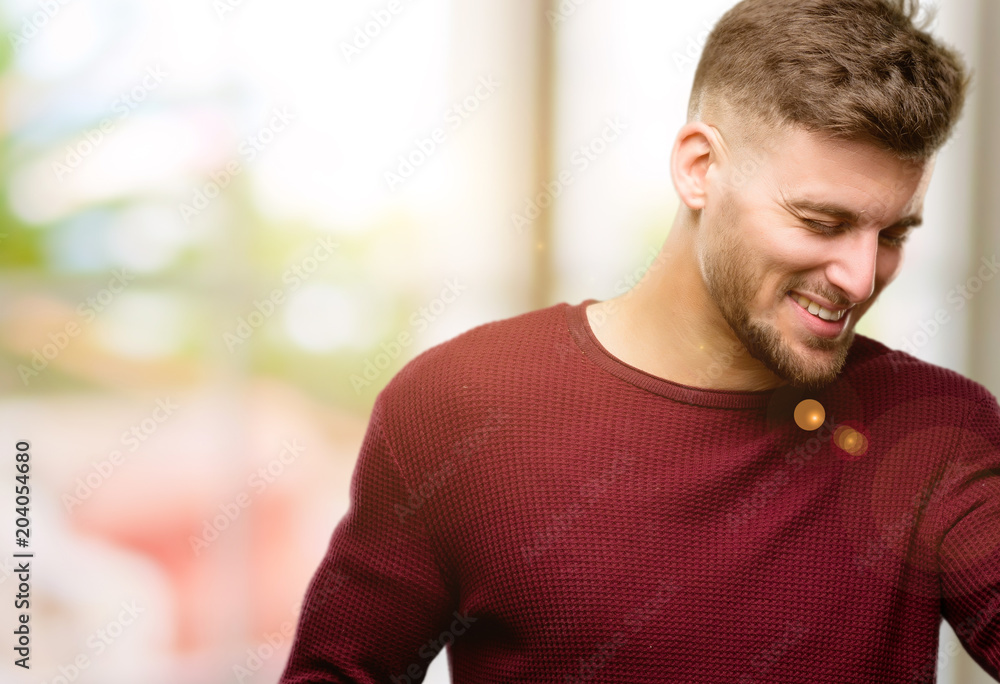 Handsome young man happy and excited celebrating victory expressing big success, power, energy and positive emotions. Celebrates new job joyful Handsome young man happy and excited celebrating victory expressing big success, power, energy and positive emotions. Celebrates new job joyful