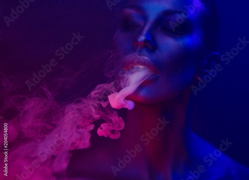 Vape Party, Nightlife. Beautiful Sexy Woman smoking photo