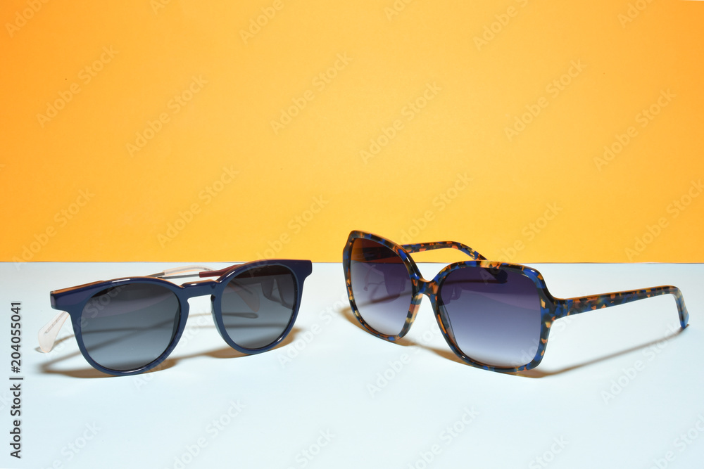 sunglasses / eyewear on pastel color paper background sunglasses / eyewear on pastel color paper background