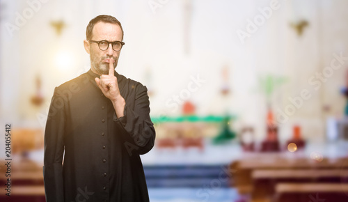 Cuadro en lienzo Priest religion man with index finger on lips, ask to be quiet