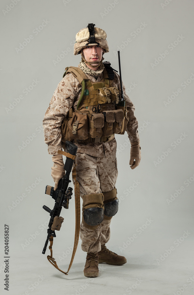 Soldier in camouflage holding rifle Soldier in camouflage holding rifle