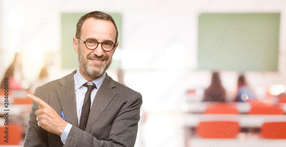 Fototapeta premium Teacher man using glasses pointing away side with finger at classroom