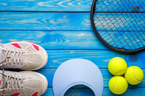 Flat lay image of  Big tennis.Still life from sneakers, a racket, a ball, a hat.Space for creative design.