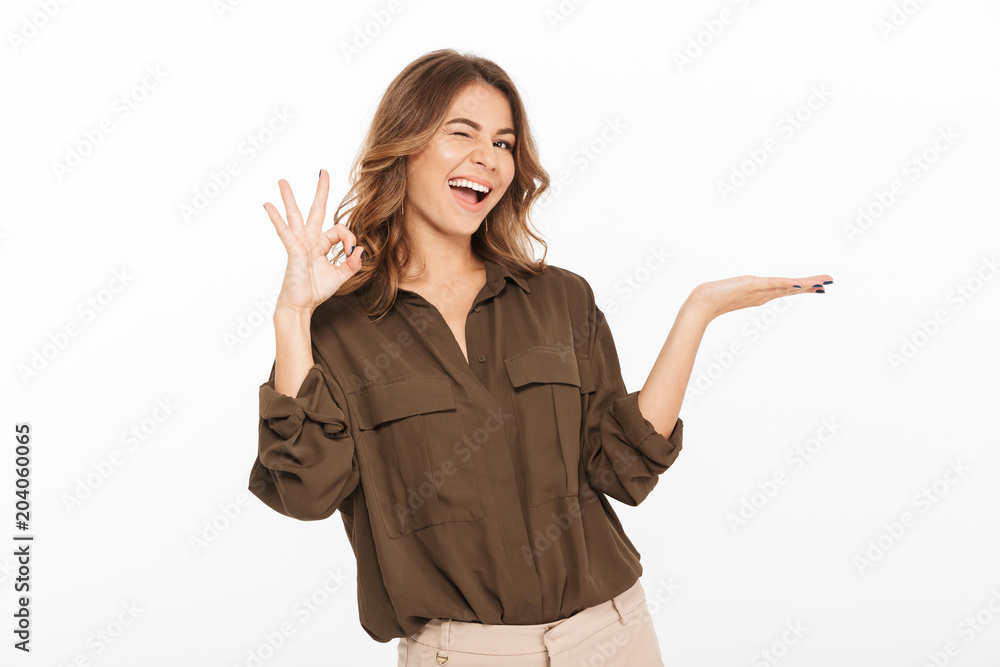 Portrait of an excited young woman holding copy space