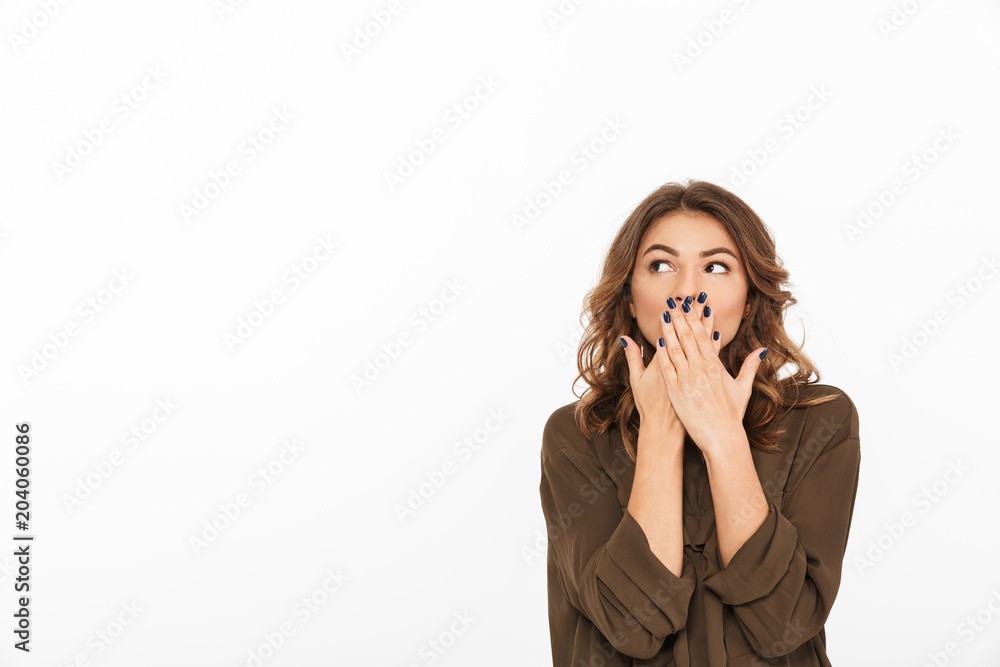 Portrait of a shocked young woman covering mouth Portrait of a shocked young woman covering mouth