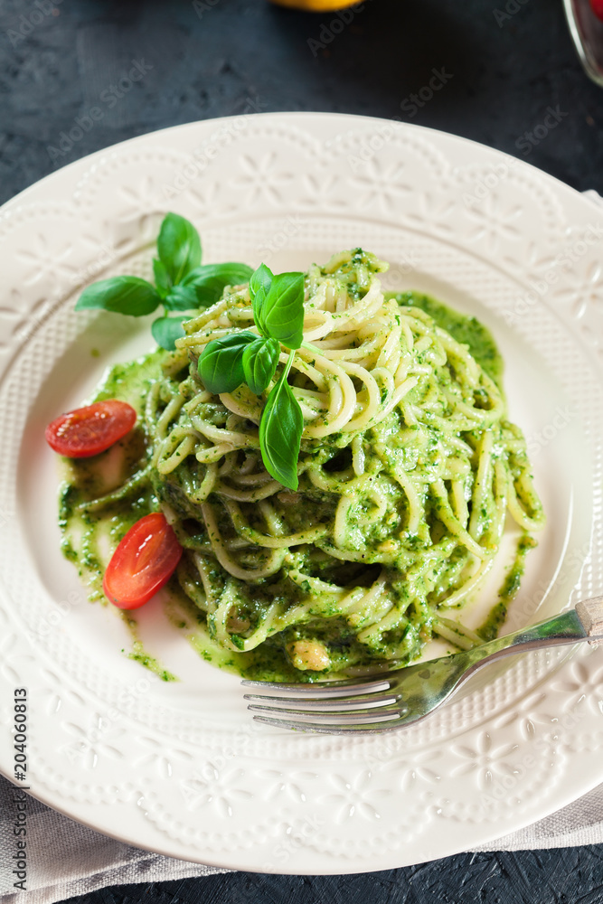 Pasta spaghetti with homemade basil pesto sauce on white plate Pasta spaghetti with homemade basil pesto sauce on white plate