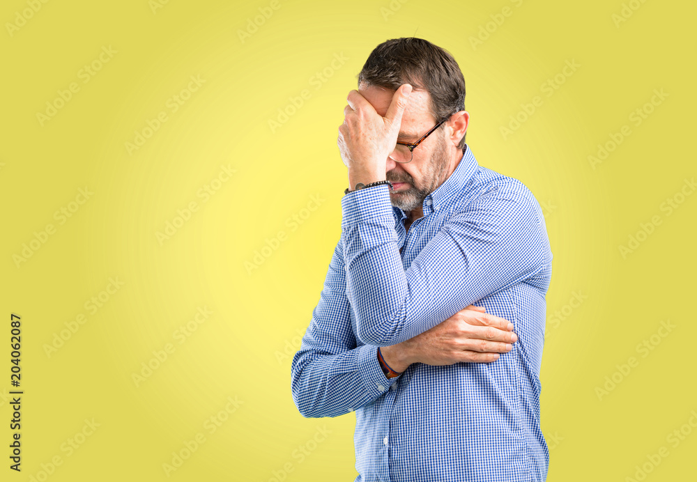 Handsome middle age man stressful keeping hands on head, tired and frustrated Handsome middle age man stressful keeping hands on head, tired and frustrated