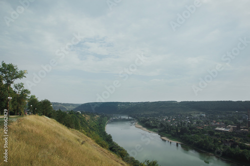 Wallpaper Mural Beautiful view on the river and village in summer. Amazing natural landscape with dry yellow grass and green trees. Torontodigital.ca