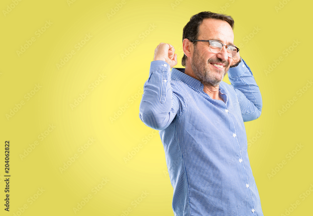 Handsome middle age man showing biceps expressing strength and gym concept, healthy life its good Handsome middle age man showing biceps expressing strength and gym concept, healthy life its good