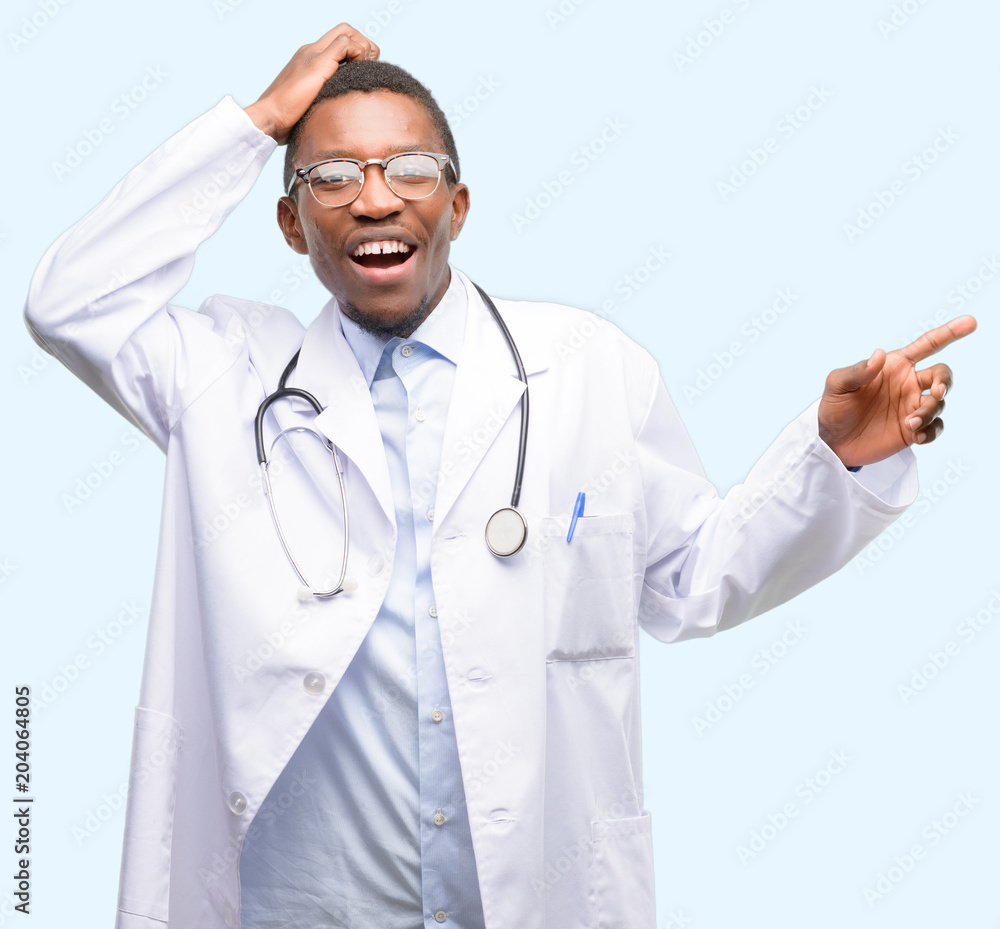 Young black doctor, medical professional pointing away side with finger Young black doctor, medical professional pointing away side with finger