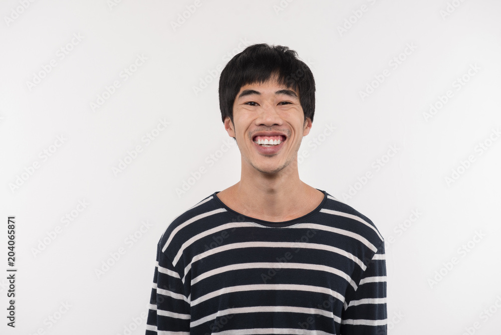 Happy smile. Cheerful Asian man looking at you while standing against white background Happy smile. Cheerful Asian man looking at you while standing against white background