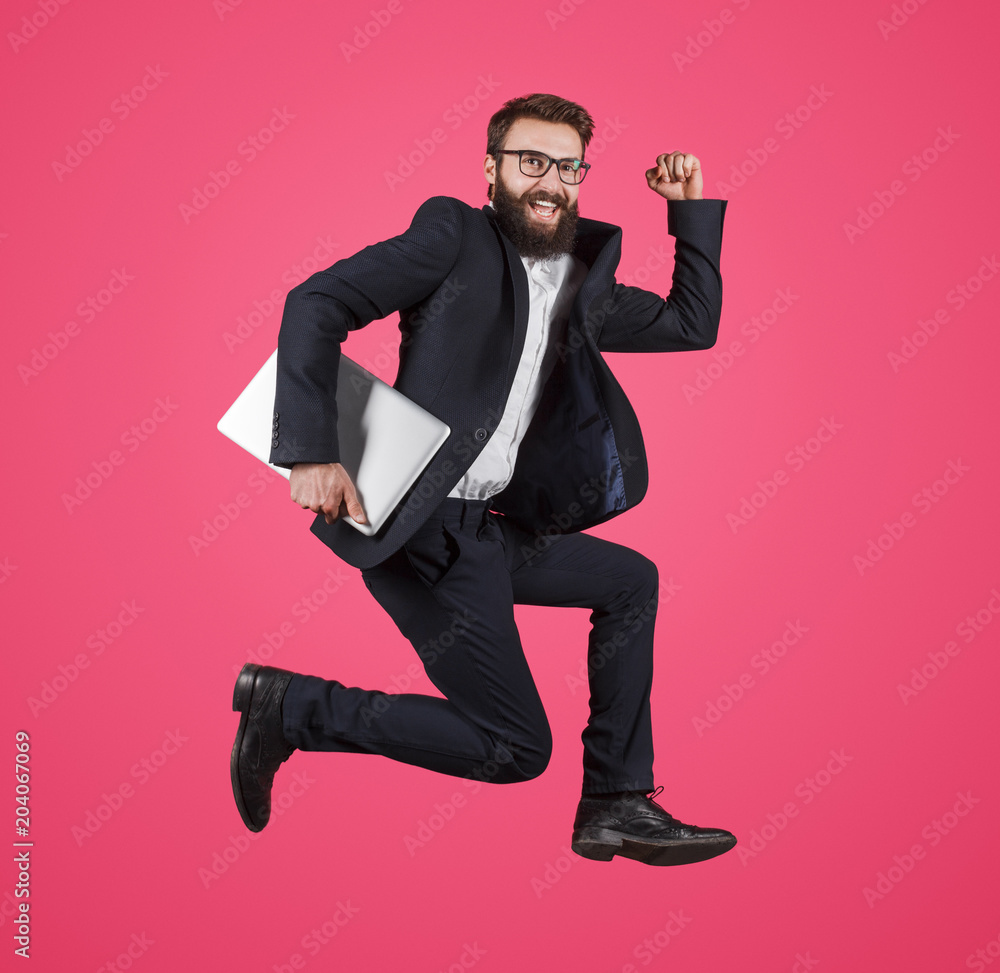 Excited man running with laptop Excited man running with laptop