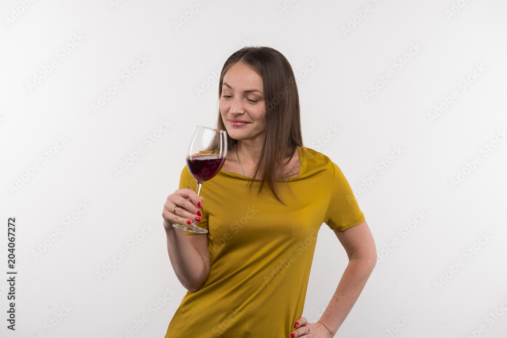 Alcoholic drink. Joyful nice woman drinking wine while being in a great mood Alcoholic drink. Joyful nice woman drinking wine while being in a great mood