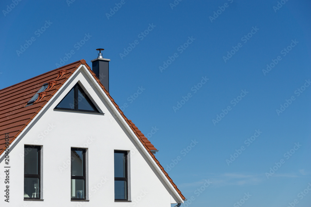 part of a facade of a new house a sunny day with blue sky and no clouds part of a facade of a new house a sunny day with blue sky and no clouds