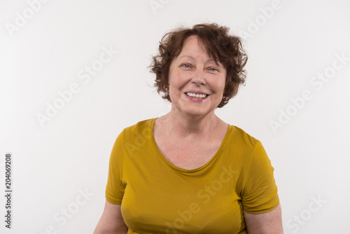 Mature age. Cheerful elderly woman smiling while looking at you