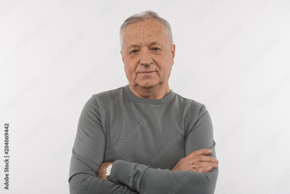 Thoughtful look. Nice aged man standing cross handed while looking at you Thoughtful look. Nice aged man standing cross handed while looking at you