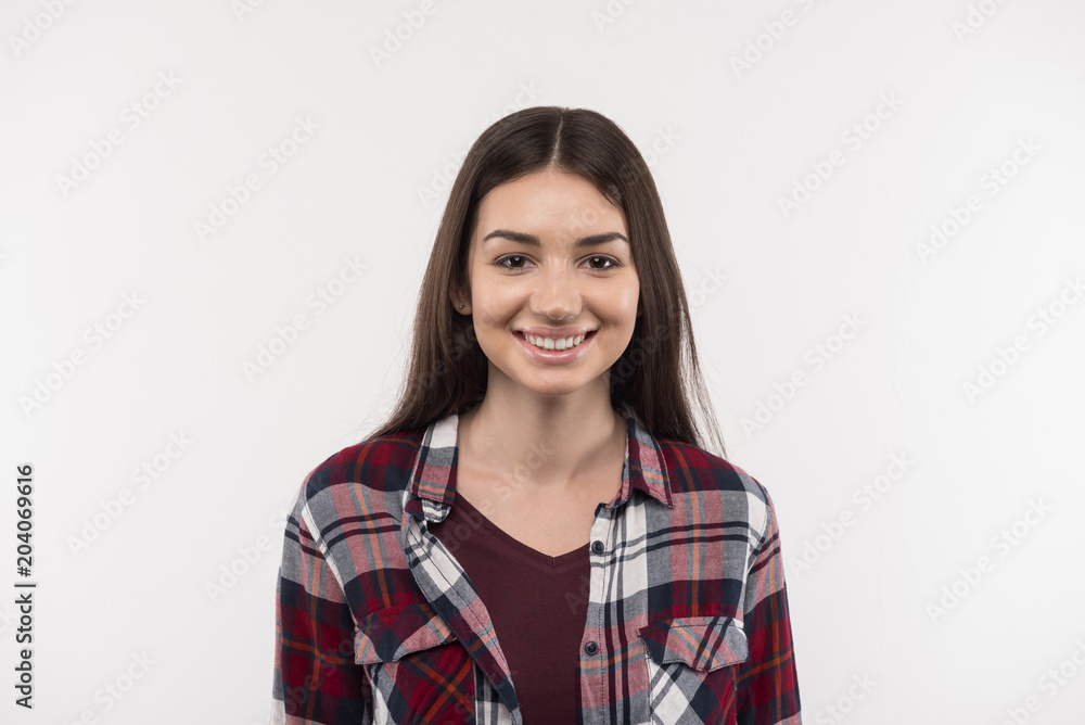 Wonderful mood. Happy young woman smiling to you while being in a great mood Wonderful mood. Happy young woman smiling to you while being in a great mood