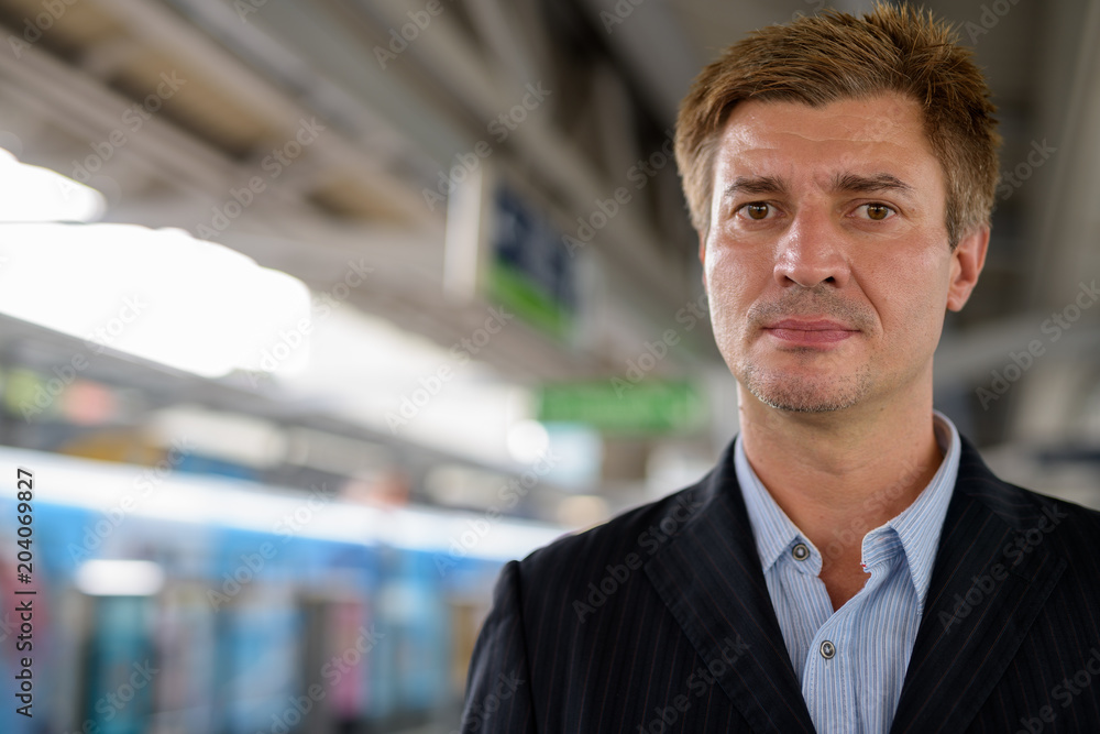Businessman at the sky train station in Bangkok, Thailand Businessman at the sky train station in Bangkok, Thailand