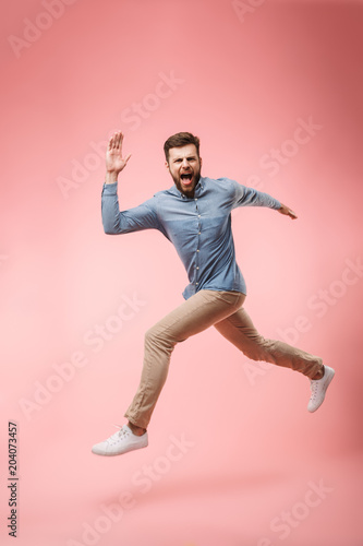 Full length of a cheerful young man running