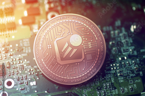 shiny copper STARTA cryptocurrency coin on blurry motherboard background photo