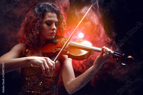 Violinist girl performs on stage.