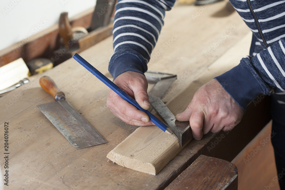 carpenter drawing on a wooden board.copy space carpenter drawing on a wooden board.copy space