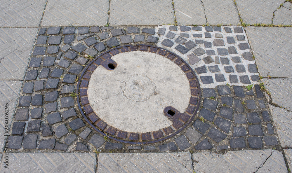 Repaired man hole cover on the square