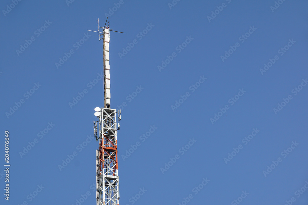 Mobile phone communication antenna tower with satellite dish on blue sky background, Telecommunication tower Mobile phone communication antenna tower with satellite dish on blue sky background, Telecommunication tower