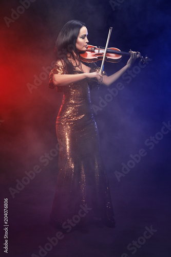 Violinist girl performs on stage.