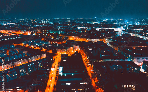 Canvas Print panoramic overview over berlin at night with blurred orange traffic lights
