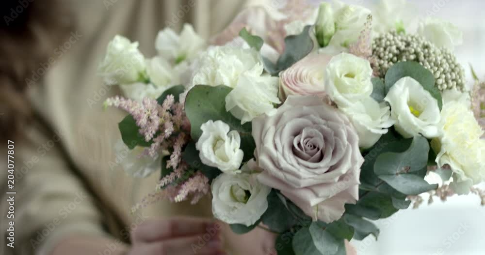 Young Florist Assembles a Rustic Wedding Bouquet. She's happy to have small business Young Florist Assembles a Rustic Wedding Bouquet. She's happy to have small business