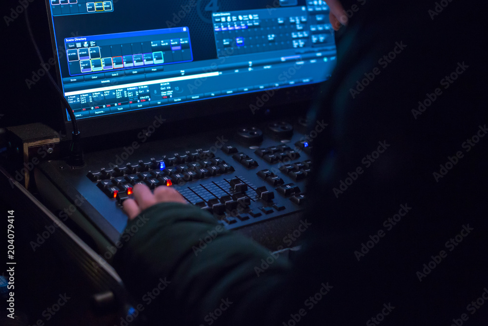 Soundman working on the mixing console. Soundman working on the mixing console.