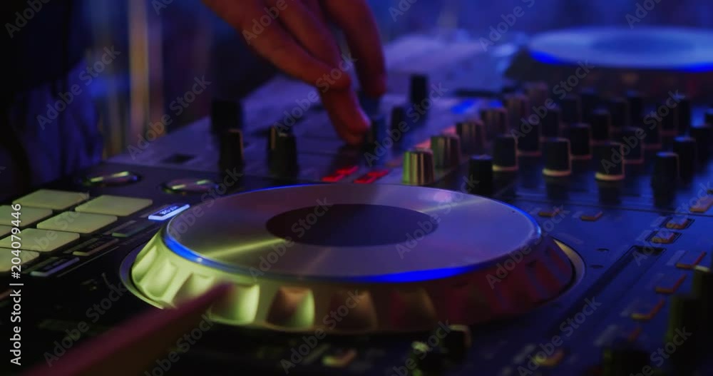 Party DJ. Nightclub dj perfoming on a party. He's handsome and energetic, dressed in stylish suit. He plays good music!