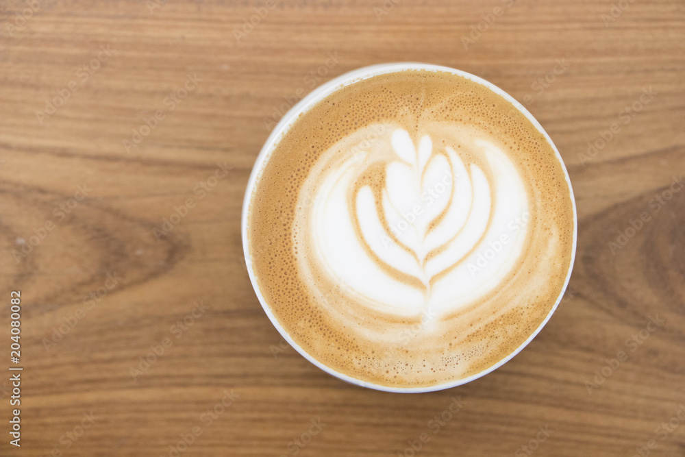 Latte art hot coffee top view.Coffee art on wooden table background. Latte art hot coffee top view.Coffee art on wooden table background.