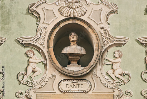 Vintage sculpture portrait of Dante Alighieri, a major Italian poet of the Late Middle Ages on a facade of an old building in Bellinzona, Switzerland photo