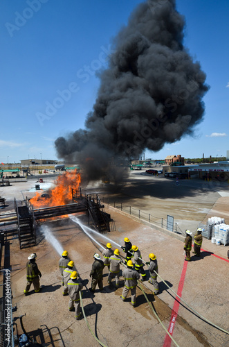 Fire fighters battling a blaze at oil pipeline refinery