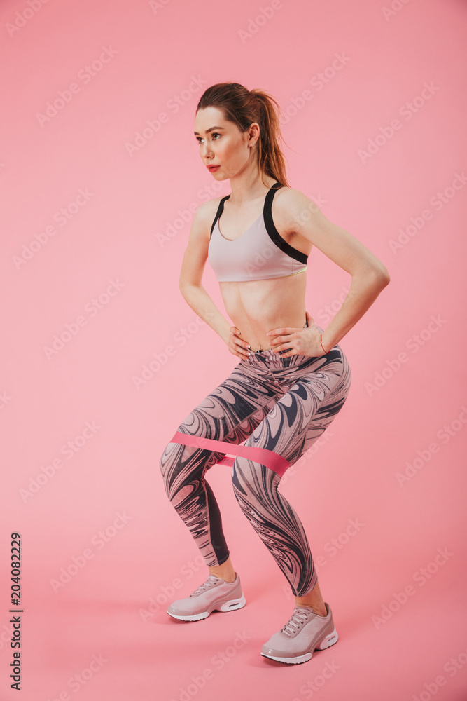Vertical image of calm sportswoman doing fitness exercise Vertical image of calm sportswoman doing fitness exercise