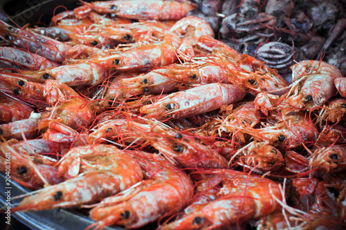a lot of freshly prepared shrimps on a platter