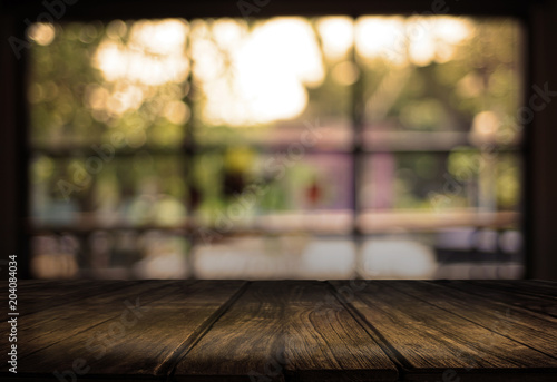 Wooden board empty table cafe, coffee shop, bar blurred background can be used for display or montage your products and Mock up