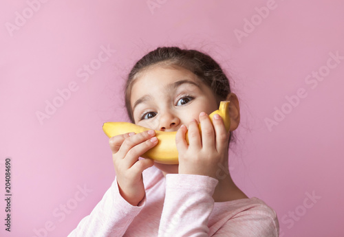 Little girl with yellow banana like smile